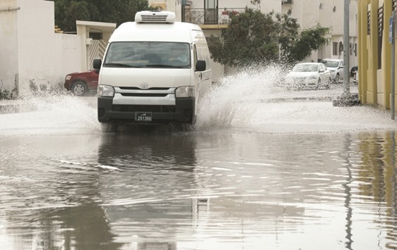 A vehicle making its way through a water-logged road in Doha yesterday. PICTURE: Thajudheen