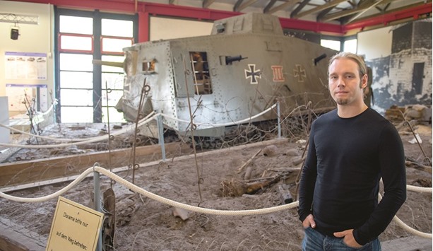 Museum director Ralf Raths with the A7V in the background.