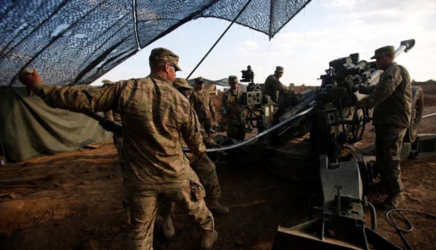 US soldiers from the 2nd Brigade, 82nd Airborne Division clean the barrel of artillery at a military base north of Mosul.