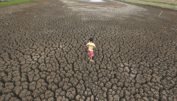 Natan Cabral, 5, stands on the cracked ground of the Boqueirao reservoir in the metropolitan region of Campina Grande, Paraiba state.