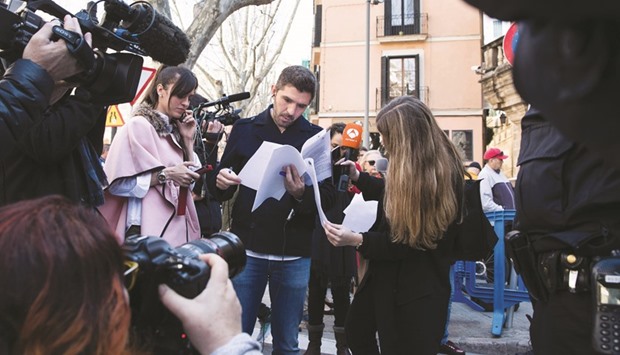 Journalists read the court sentence outside the court in Palma de Mallorca.