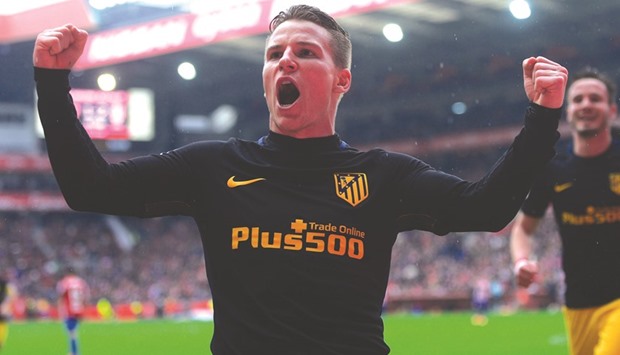 Atletico Madridu2019s French forward Kevin Gameiro celebrates his hat-trick against Sporting de Gijon yesterday. (AFP)