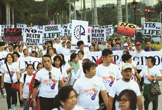 Participants join a u201cprocessionu201d against plans to reimpose death penalty and to intensify the drug war during u201cWalk for Lifeu201d in Luneta Park, Metro Manila yesterday.