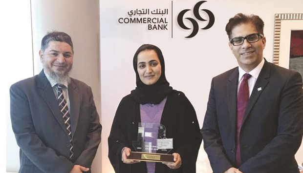 Commercial Bank executives with u2018Best investor relationsu2019 award for mid-cap companies the bank won at the Qatar Stock Exchangeu2019s 2nd Annual Investor Relations Excellence Programme Awards ceremony.
