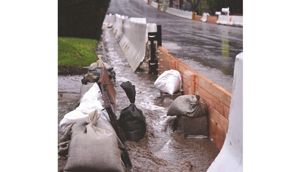 K-rails (also known as Jersey barriers) and sandbags are placed in front of homes in Duarte.