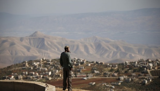 Jewish settler Refael Morris stands at an observation point overlooking the West Bank village of Duma, near Yishuv Hadaat, an unauthorised Jewish settler outpost January 5, 2016