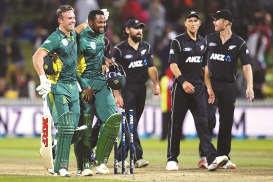 South Africau2019s AB de Villiers (left) and teammate Andile Phehlukwayo celebrate winning the ODI against New Zealand at Seddon Park in Hamilton yesterday. (AFP)