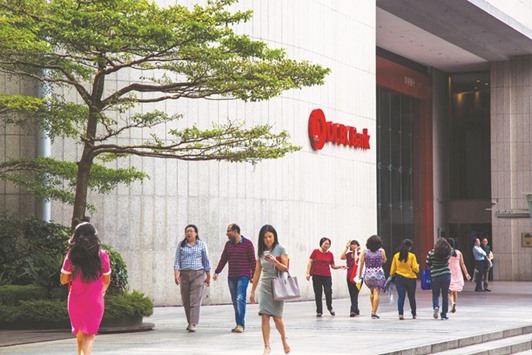 Pedestrians walk past an Overseas-Chinese Banking Corp (OCBC) branch in the central business district of Singapore. The private banking arm of Singaporeu2019s second-biggest lender OCBC is targeting annual growth of assets of more than 20% from its new office in Dubai, which it aims to use to attract wealthy clients from the Middle East and Africa.
