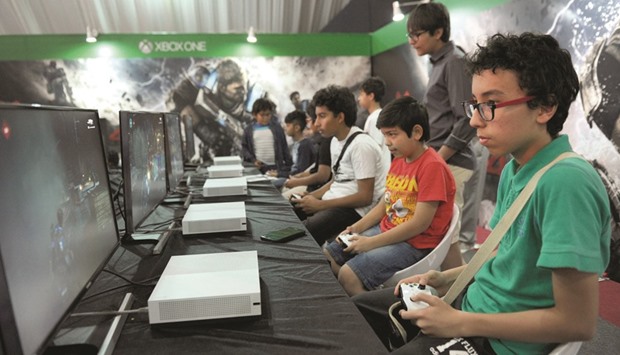 Boys play games during Comic Con expo in Jeddah.