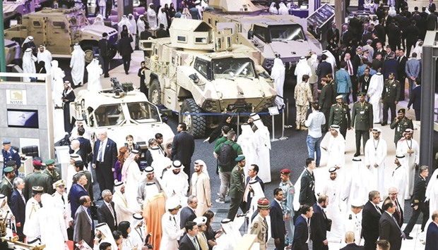 A general view of visitors walking in a showroom displaying armoured military vehicles during the opening of the International Defence Exhibition and Conference (IDEX) in Abu Dhabi yesterday.