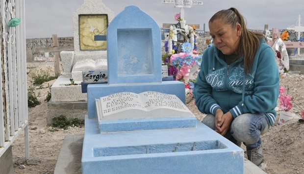 Maria Guadalupe Guereca, 60, visits the grave of her murdered son Sergio Hernandez