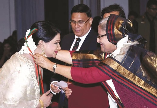 Prime Minister Sheikh Hasina giving away highest civilian award Ekushey Padak to noted dancer Shamim Ara Nipa on the occasion of Mother Language Day in Dhaka yesterday.