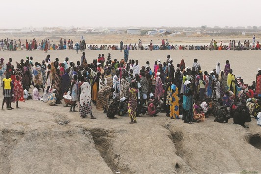 People wait to receive food at the UN Mission in South Sudan, near Bentiu, northern South Sudan.