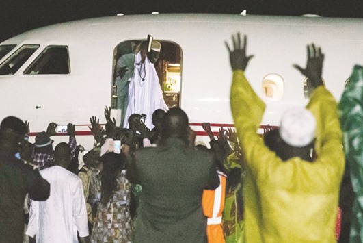 SAD, and GLAD, TO SEE HIM GO: These file photo taken on January 21 show Jammeh waving as he leaves the country.