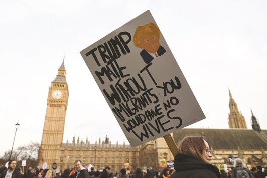 A Protester holds up an anti-Trump placard in front of the Elizabeth Tower, better known as Big Ben near the Houses of Parliament.