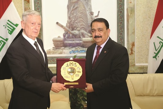 US Defence Secretary Jim Mattis receives a gift from Iraqu2019s Defence Minister Irfan al-Hayali during a visit to Baghdad yesterday.