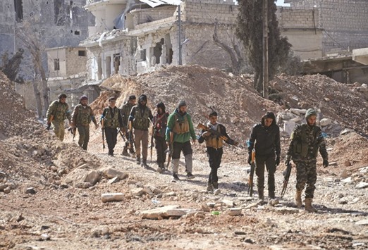 Rebel fighters, part of the Turkey-backed Euphrates Shield alliance, advance yesterday, towards the city of Al-Bab, some 30 kilometres from the Syrian city of Aleppo.