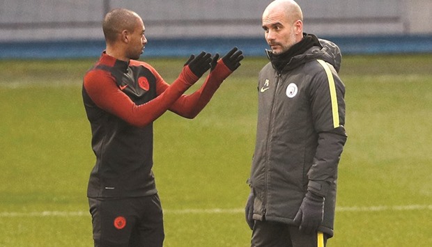 Manchester Cityu2019s Fernandinho (left) with manager Pep Guardiola during a training session in Manchester yesterday. (Reuters)