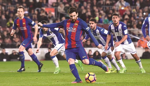 Barcelonau2019s Argentinian forward Lionel Messi shoots a penalty kick to score a goal during the La Liga game against Leganes at the Camp Nou stadium in Barcelona on Sunday. (AFP)