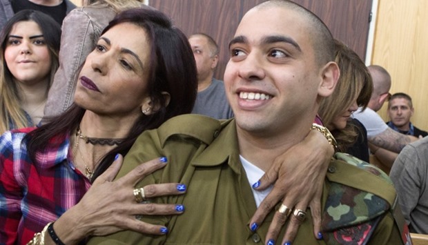 Israeli soldier Elor Azaria is embraced by his mother at the start of his sentencing hearing at a military court in Tel Aviv, Israel.