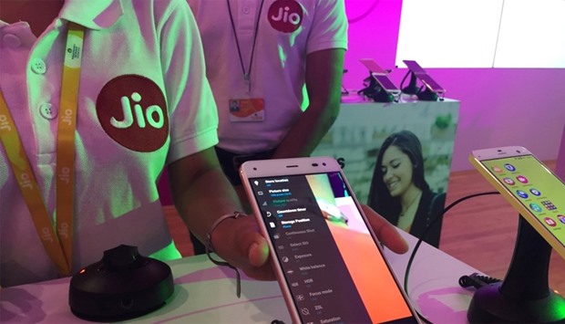 A Reliance employee demonstrates Jio LYF phone