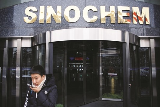 A man walks past the office building of Sinochem in Beijing. The oil and chemicals firm agreed to buy the stake from Norwayu2019s Statoil for $3.07bn in 2010, beating out a raft of Chinese rivals chasing high-quality assets.