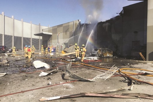 Firemen putting out a blaze at the crash site near Melbourne.