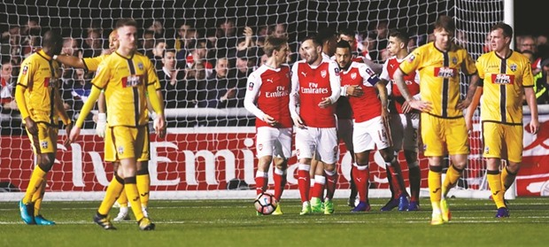 Arsenalu2019s Theo Walcott celebrates his goal against Sutton United with teammates Nacho Monreal, Lucas Perez and Gabriel Paulista in their FA Cup fifth round clash on Monday night. (Reuters)