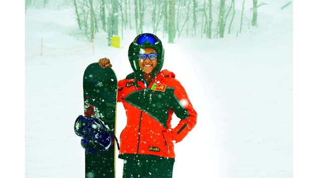 This file photo shows 16-year-old snowboarder Azquiya Usuph of Sri Lanka posing with her board in the snow at Sapporo Teine resort in western Sapporo in Japan.