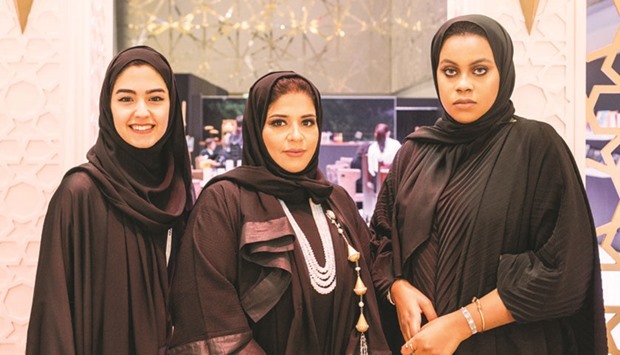 Sarah al-Hammadi (right) and Nada al-Sulaiti (middle) along with another designer at the pavilion of Young Qatari Designers at the DJWE yesterday.