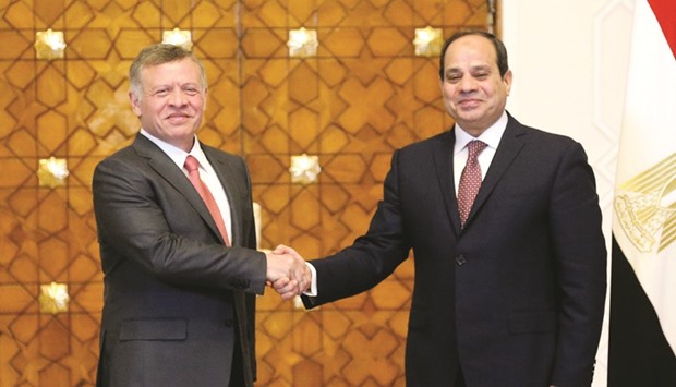 A handout picture released by the Jordanian Royal Palace yesterday, shows Jordanu2019s King Abdullah II shaking hands with Egyptian President Abdel Fattah al-Sisi during a meeting in Cairo.