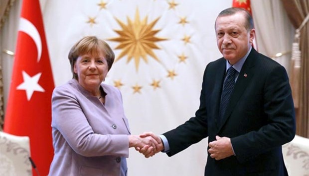 Turkish President Recep Tayyip Erdogan and German Chancellor Angela Merkel shake hands during their meeting at the Presidential Palace in Ankara on Thursday.