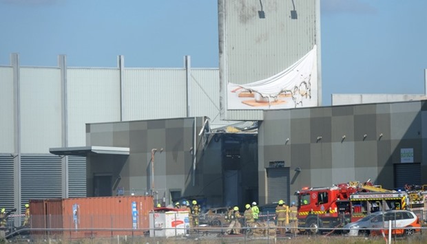 Fire crew at the scene where a light plane crashed into the back of a building at Essendon airport in Melbourne, Australia