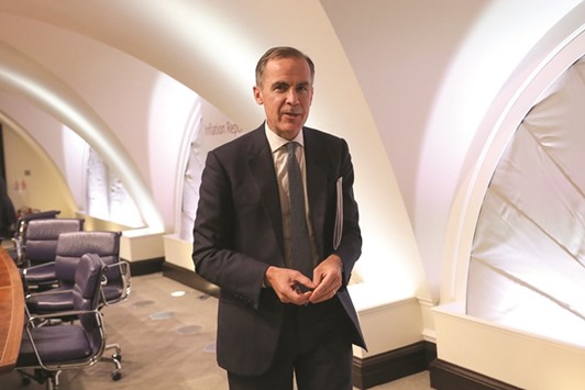 BoE governor Mark Carney leaves after the banku2019s quarterly inflation report news conference in London yesterday. Carney said that with inflation accelerating and risks to growth on the horizon, u201cwe can see scenarios in either directionu201d for policy.