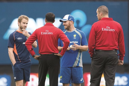Umpires Kumar Dharmasena (centre left) and Chris Brown (right) talk to captains Kane Williamson (left) of New Zealand and Aaron Finch of Australia in Napier yesterday. (AFP)