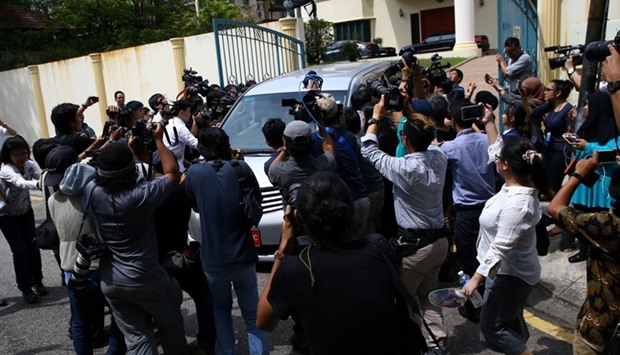 Members of the media surround a North Korea official's car as it leaves the North Korea embassy in Kuala Lumpur, Malaysia.