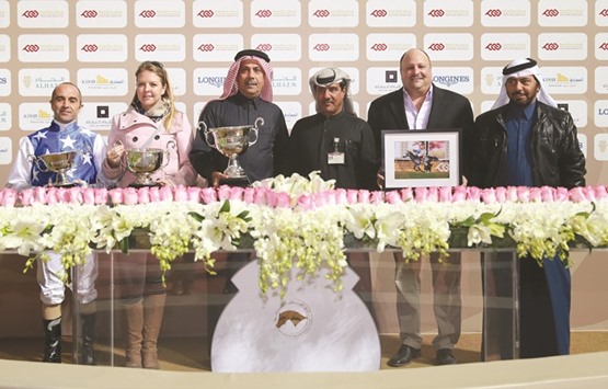 QREC vice-chief steward Abdulla Rashid al-Kubaisi (third from right) and head of Media Saad Mubarak al-Hajri (right) with the winners of the Purebred Arabian Sword Trial after Gazwan won the 2000m race at the Qatar Racing and Equestrian Club yesterday. PICTURE: Juhaim