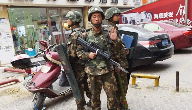 paramilitary police standing guard outside a shopping mall in China's Xinjiang region