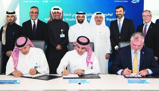 The main contractor agreement for Al Thumama Stadium being signed as al-Thawadi, architect Jaidah and other officials look on