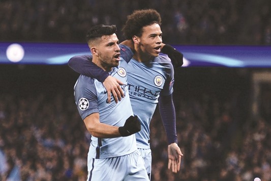 Manchester Cityu2019s Argentinian striker Sergio Aguero (L) celebrates scoring their second goal with teammate Leroy Sane (R) during their Champions League Round of 16 tie.
