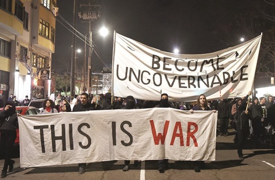 Protesters march in Berkeley, California late on Wednesday. Violent protests erupted at the University of California at Berkeley over the scheduled appearance of a controversial editor of the conservative news website Breitbart.