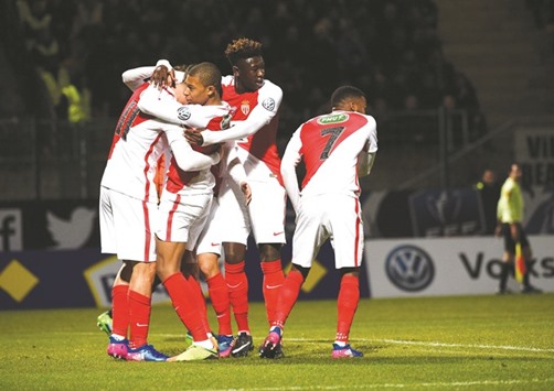 Monacou2019s Guido Marcelo Carrillo (left) celebrates with teammates after scoring a goal during the French Cup match against Chambly at Brisson stadium in Beauvais. (AFP)