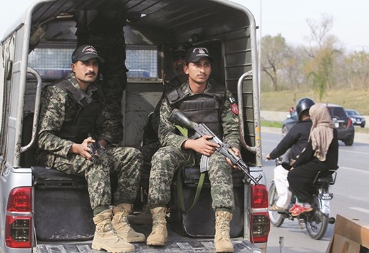 Pakistani Rangers personnel keep guard while patrolling on the streets in Islamabad.