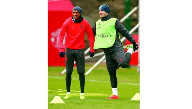 Manchester Unitedu2019s Ashley Young (L) and Wayne Rooney during a training session.