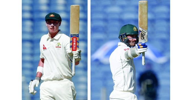 Australiau2019s Matt Renshaw (L) and Mitchell Starc celebrate their half centuries during the first day of the first Test against India in Pune. (Reuters)