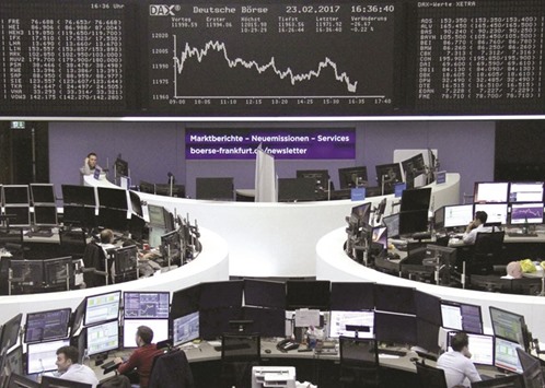 Traders are seen at the Frankfurt Stock Exchange. The DAX 30 lost 0.4% at 11,947.83 yesterday.