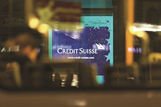 A sign sits illuminated inside the window of the Credit Suisse Group headquarters in Zurich. The Swiss lender seeking a banking licence in Saudi Arabia, has allocated about $600mn of its own capital to expand its business in the kingdom, according to people familiar with the matter.