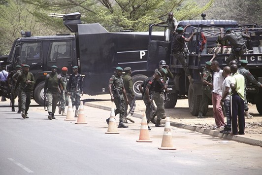 Nigerian security forces take position outside the DSTV Nigerian headquarters in Abuja.