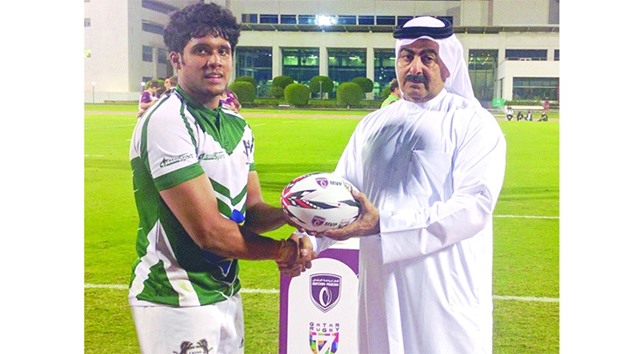 Lions RFCu2019s Sharith Amit (left) receives the Man of the Match award for his stellar performance in the Plate finals victory against the Stallions in the Qatar Rugby 7s from Qatar Rugby Federation president Yousef al-Kuwari at the Aspire Warm-Up Track in Doha on November 25, 2016.