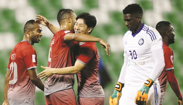 Lekhwiyau2019s Youssef al-Arabi (2 from left) is congratulated by Nam Tae-hee after his goal against Al Sailiya yesterday.
